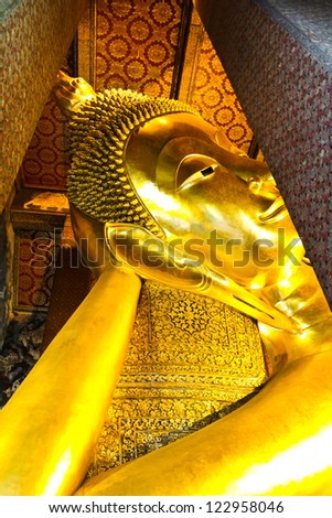 BANGKOK, THAILAND - DEC 22: Details of the Reclining Buddha statue at the Wat Pho temple on December 22, 2012 in Wat Pho temple, Bangkok,Thailand. The reclining Buddha is 15m high and 43m long.