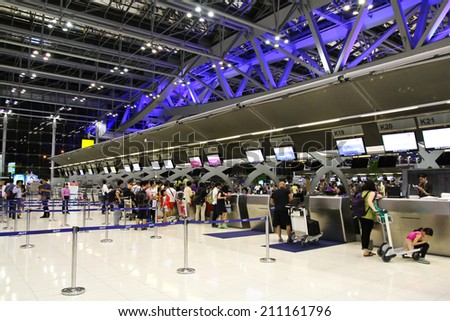BANGKOK - AUGUST 15 : People waiting in check-in line K terminal of the Bangkok airport on August 15, 2014. Suvarnabhumi airport is world\'s 4th largest single-building airport terminal.