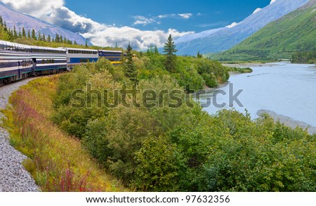 A Train Travels Through Beautiful Alaskan Landscape