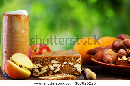 mug of beer, bread and fruits