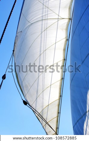Full Sails on wind and blue sky