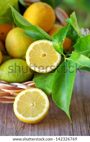 Basket of lemons and half lemons on table
