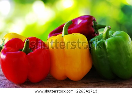 red, yellow and green pepper on green background