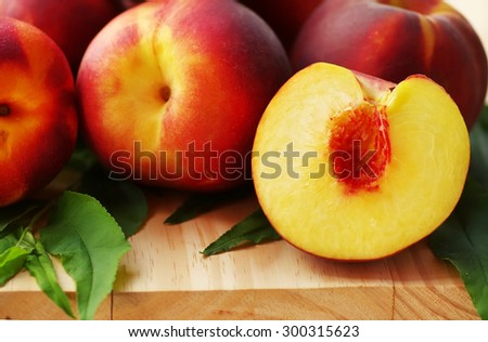 sliced peaches and leaves on table