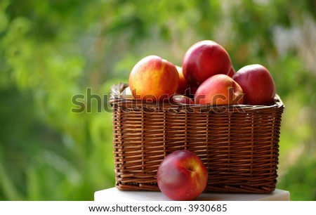 Small hamper of fruit with red peaches.