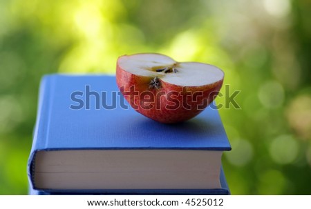 Half of the apple on book.