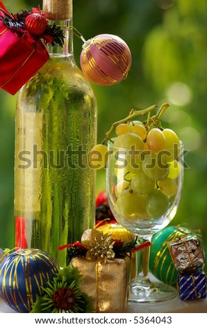 Decorated bottle of white wine with Christmas presents.