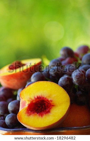 Half of peach with red grapes.
