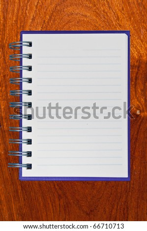 Purple notebook on wood texture