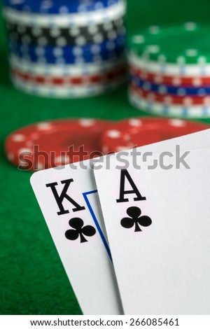 A poker hand of ace king of spades with chips in background