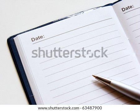 Open note book with lined pages free date space and ballpoint pen