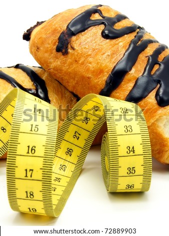 Chocolate danish pastry cake & measuring tape in diet concept