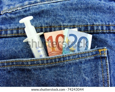 Drug Money - Hypodermic needle & cash in back pocket of dark jeans