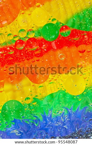Rainbow coloured circles with splash effect. Abstract background