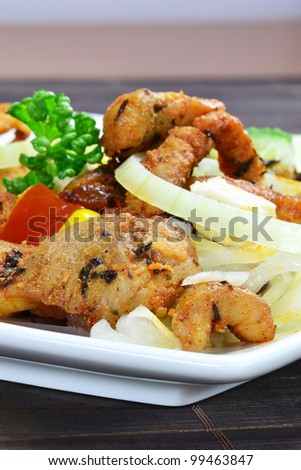 A meal of grilled meat and mixed salad on a plate