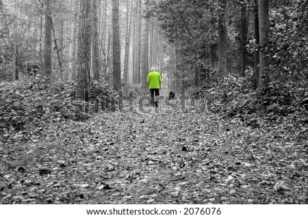 Old man walking his dog in the forest