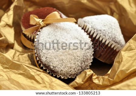 Chocolate muffins packed in golden paper
