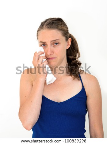 Sad woman with tissues on white background