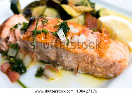 grilled salmon and lemon - french cuisine dish with tomato and salmon