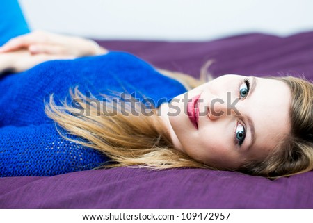 Beautiful young woman on the bed