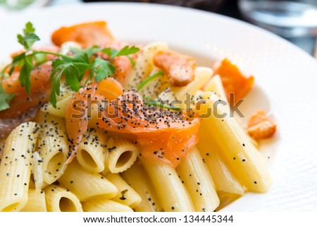 close-up of plate of pasta and smoked salmon with tomato