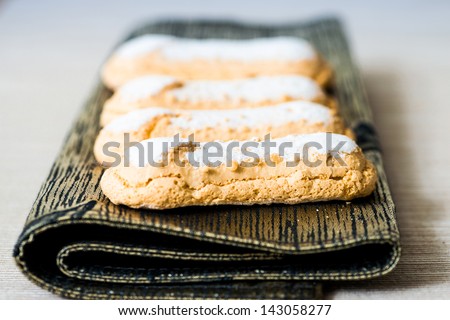 sponge fingers sugar biscuit on brown napkin