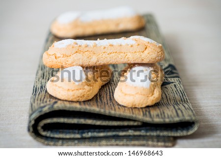 sponge fingers sugar biscuit on brown napkin
