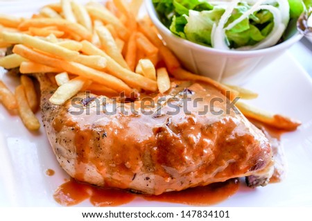 delicious chicken with sauce and golden French fries potatoes