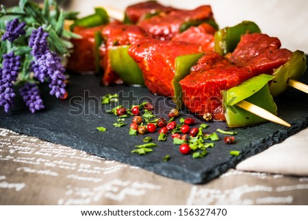 tasty meat and vegetables skewers on a slate plate