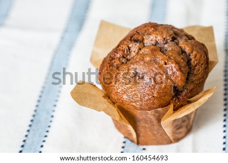 Homemade muffins in paper on napkin