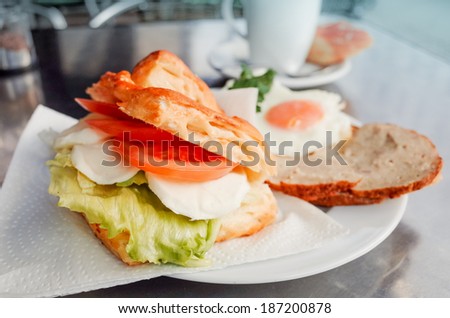 Sandwich with bacon, tomato- chicken, cheese and lettuce