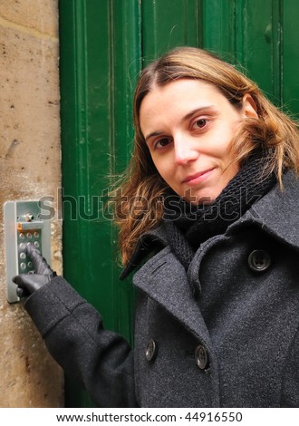 young woman pushing the access code,paris france