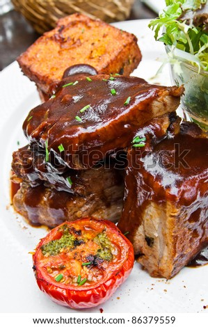 Grilled steak - Grilled meat ribs on the plate with hot sauce