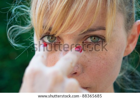 angry young woman pointing to the eyes