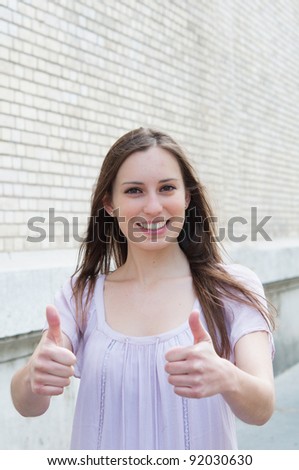 smiling beautiful happy woman with thumbs up