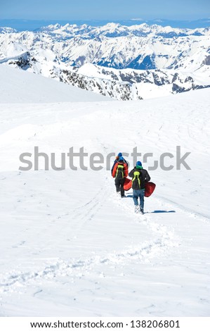 A group of mountain hiker walking on the snow into the mountain