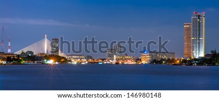 Panorama View of Chaopraya River with Bridges and Building at Night Time in Bangkok, Thailand