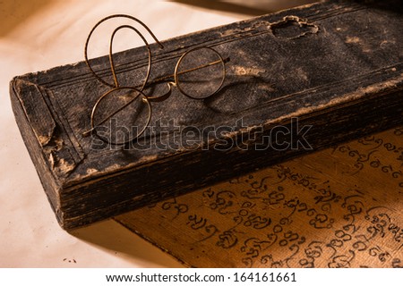 Hand Written Ancient Treatise of Lanna character with very old glasses