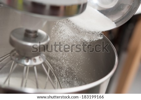 Adding sugar into mixing machine