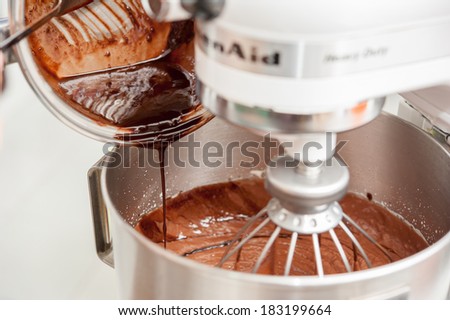 Mixing flour, eggs, sugar and hot chocolate in mixing machine