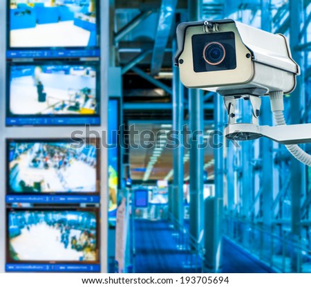 CCTV Camera or surveillance operating with monitor in background