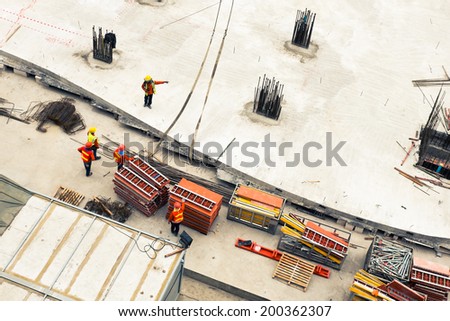 Construction workers working in site lifting tools