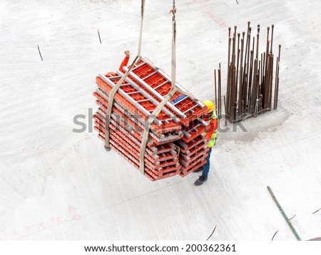 Construction workers working in site lifting tools