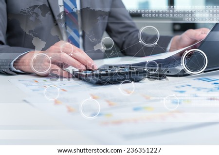 Close up of business man typing on laptop computer with technology layer effect