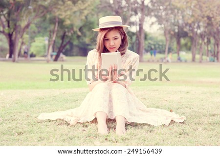 Vintage Girl sit in park listen music via small talk