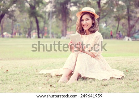 Vintage Girl sit in park listen music via small talk