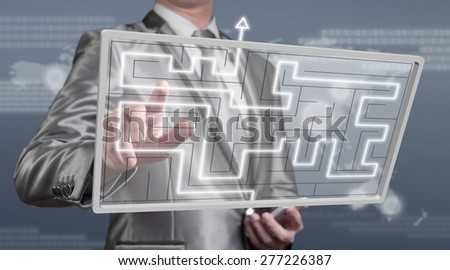 businessman working on digital screen of maze, business strategy concept