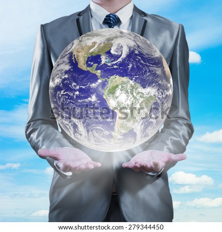 businessman holding earth with sky in background, business globalization concept, Elements of this image furnished by NASA