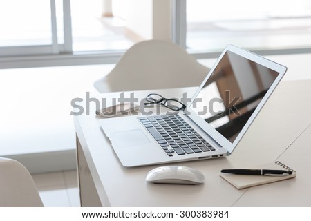 laptop with smart phone and note book on work desk