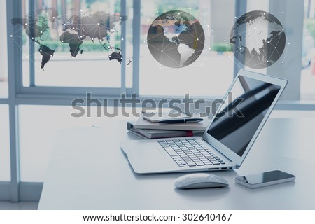 work desk with laptop, smartphone, note book and organizer, globalization concept